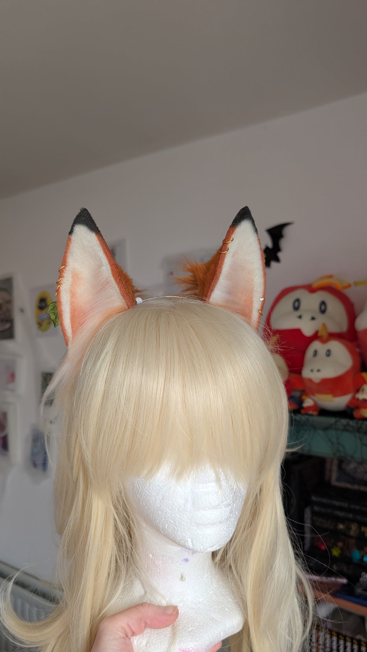 white and amber with black tips fox ears, with golden piercings